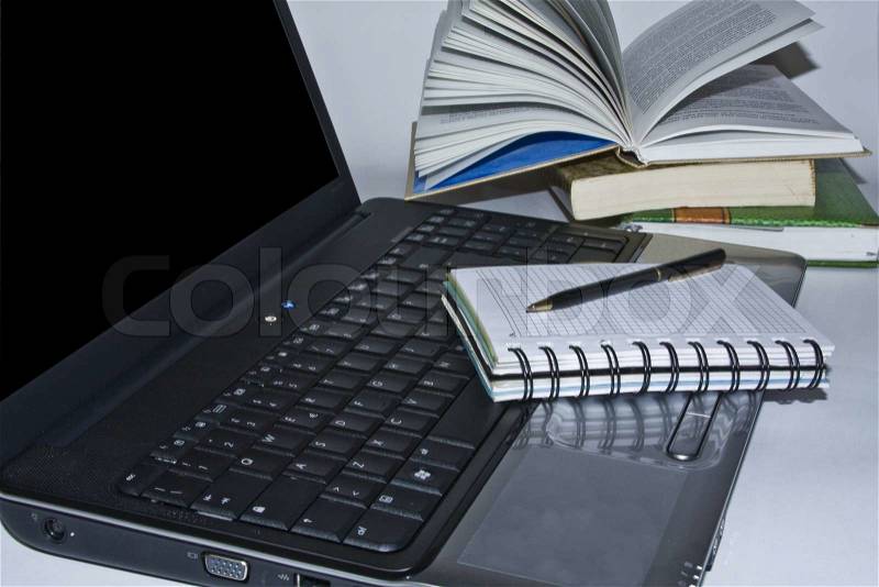 Laptop computer, pen and books, stock photo