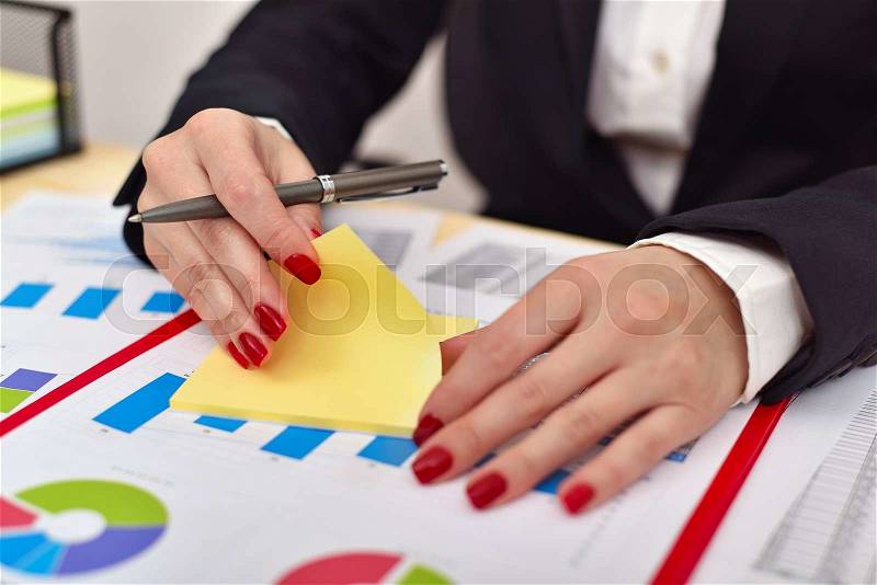 Accountant woman tears off sticker, close up, stock photo