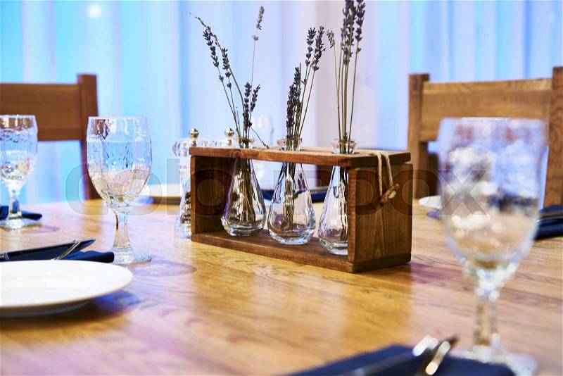Serving dinner table with herbarium design in a restaurant, stock photo