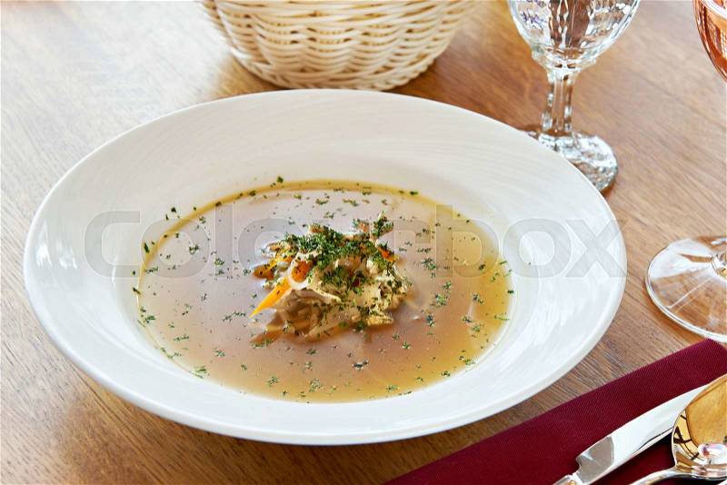 Chicken soup on dinner table in the restaurant, stock photo