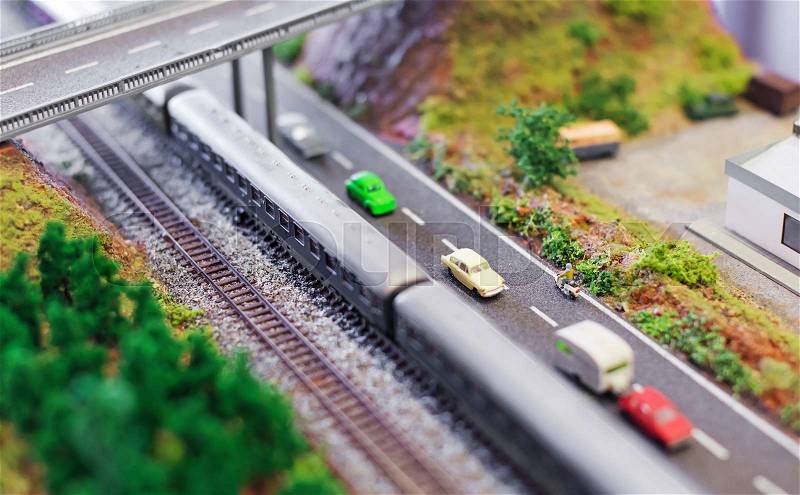 City in miniature. Electric train near the speedway, stock photo