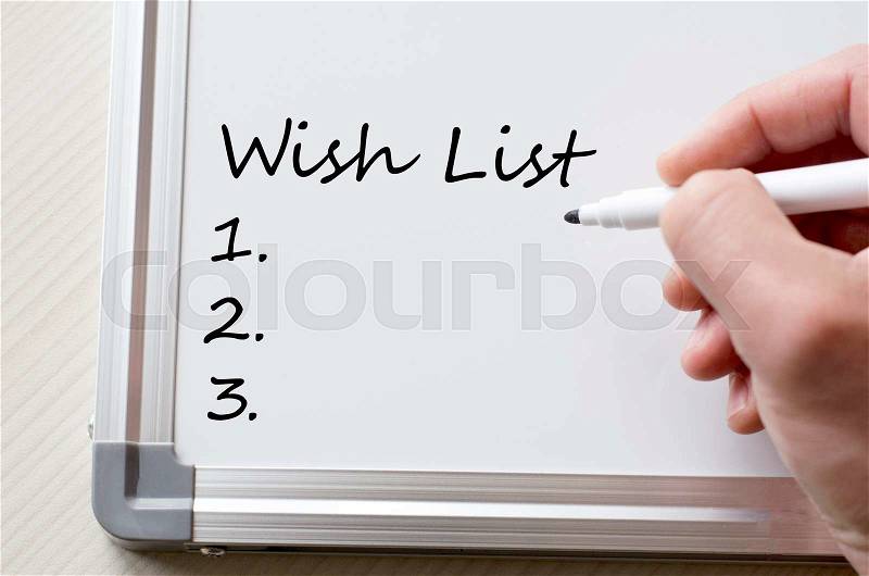 Human hand writing wish list on whiteboard, stock photo