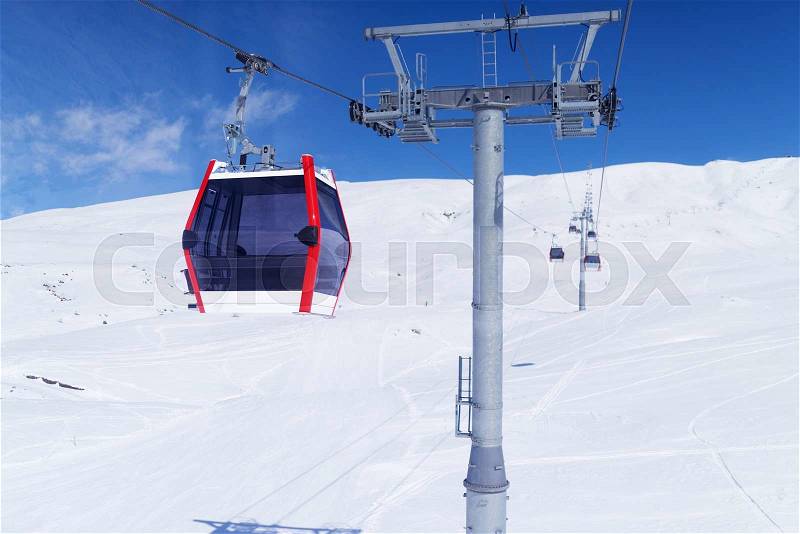 Gondola lift in the ski resort rises up the hill. Cableway in the mountains, stock photo