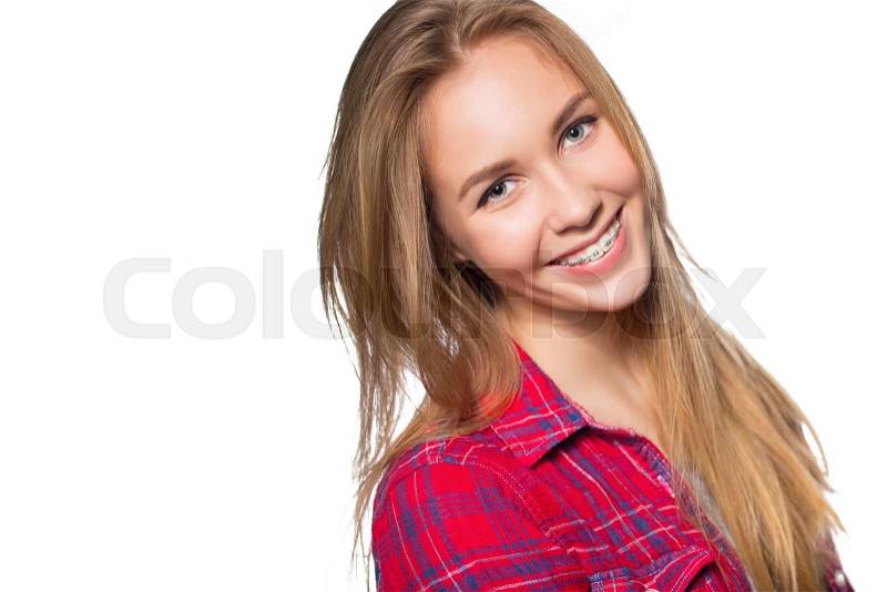 Close up portrait of smiling teen girl showing dental braces. Isolated on white background, stock photo