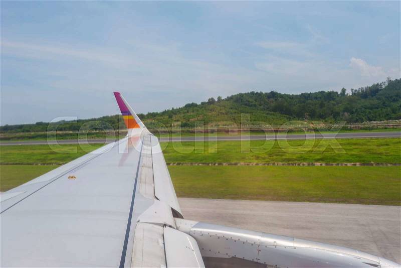 The wings of the plane take off or landing, and the beautiful view from the glass window of the plane, stock photo
