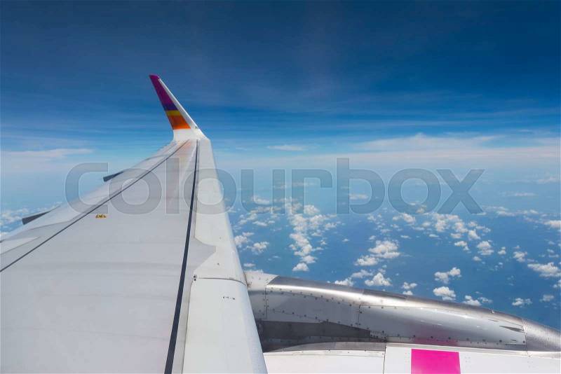 The wings of the plane, and the beautiful view from the glass window of the plane, stock photo