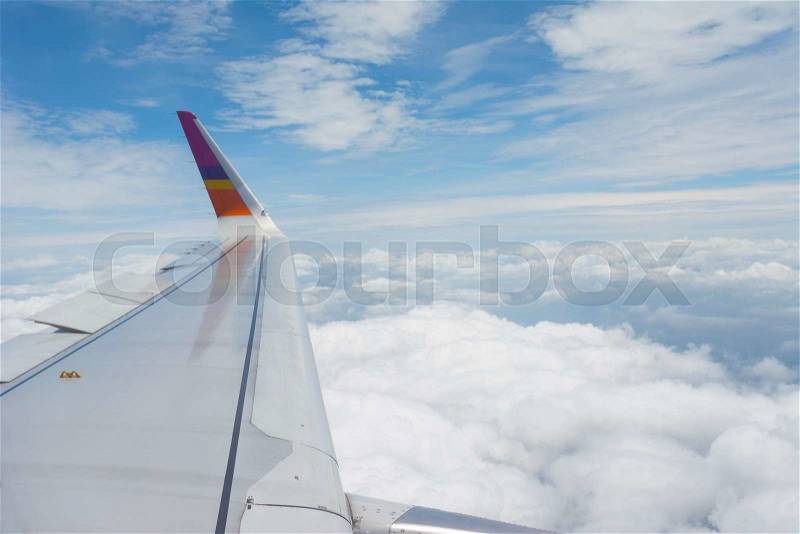 The wings of the plane, and the beautiful view from the glass window of the plane, stock photo