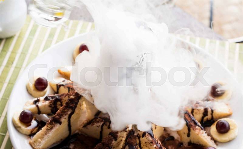 Honey toast and banana wtih dry ice on table background,focus dry ice, stock photo