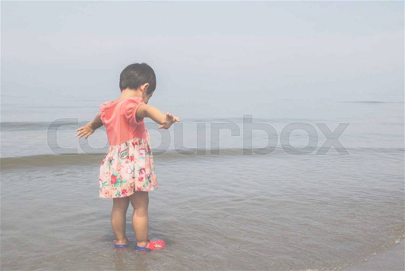 The girl was glad to see the sea. Vintage filter, stock photo