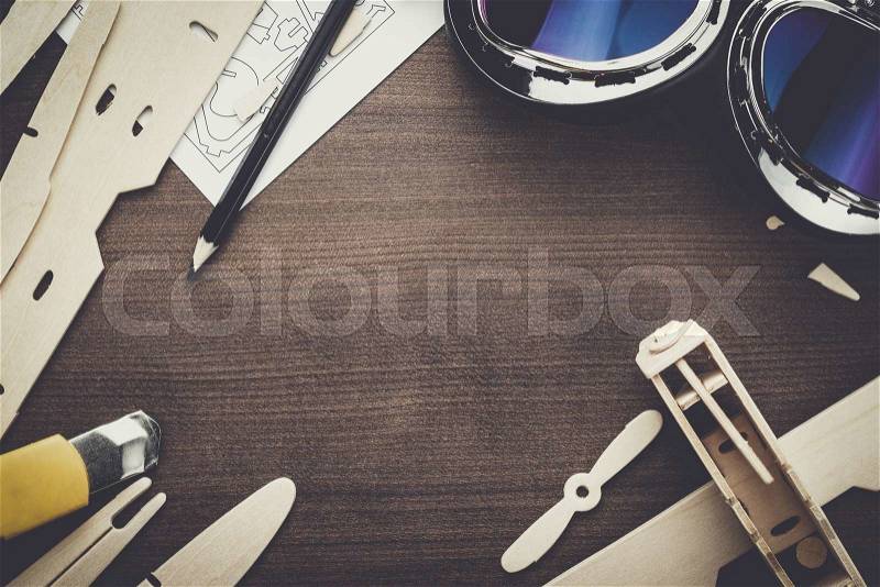 Handmade airplane on the brown wooden table, stock photo