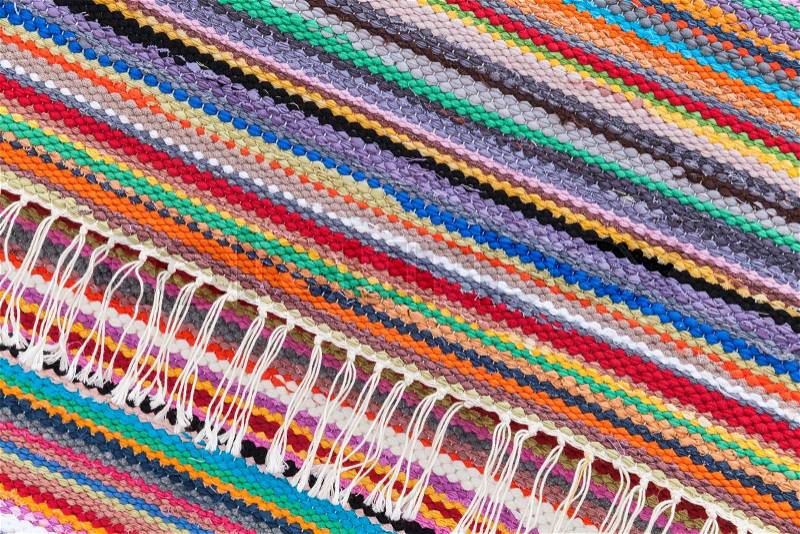 Colorful abstract patchwork rug with striped pattern, background photo texture, stock photo