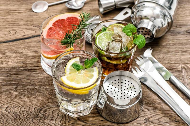 Fruit drinks with ice. Cocktail making bar tools, shaker, glasses, mint leaves, stock photo
