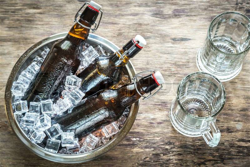Bottles of beer in ice cubes, stock photo
