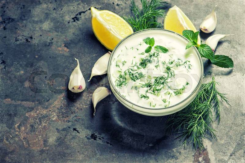 Tzatziki sauce. Fresh dip with yogurt, herbs dill and mint. Vintage style toned picture, stock photo
