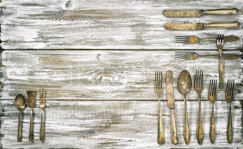 Antique cutlery on rustic wooden background. Retro kitchen utensils. Vintage style toned picture, stock photo