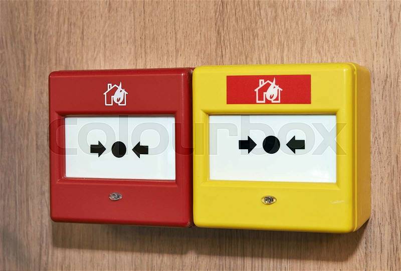 Close up of a fire alarm system on a wood panel, stock photo