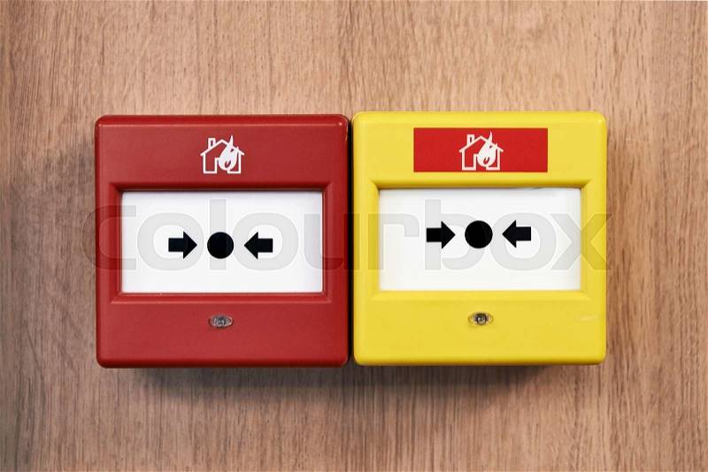 Close up of a fire alarm system on a wood panel from front, stock photo