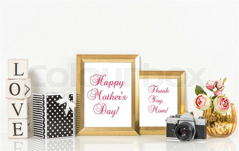 Golden picture frames, roses flowers and no name vintage camera. Copy space for Your designs. Happy Mothers Day, stock photo