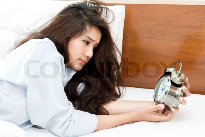 Young Asian woman insomnia until 2 o\'clock, stock photo