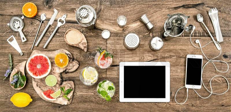 Kitchen table with bar tools, accessories and electronic devices. Flat lay background, stock photo
