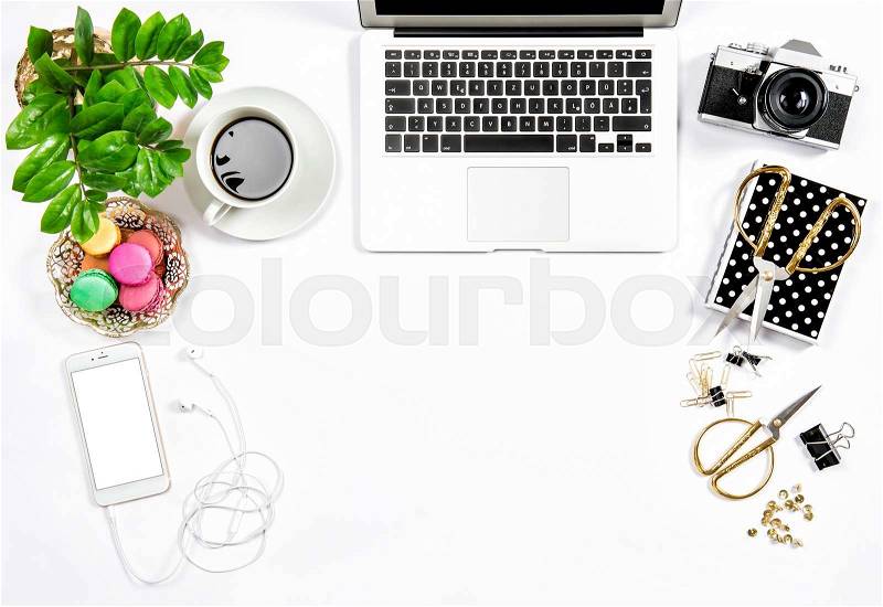 Office supplies and laptop. Business still life. Coffee and macaroon cookies. Flat lay, stock photo