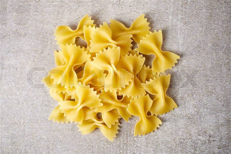 Bow tie pasta on stone table, from above, stock photo