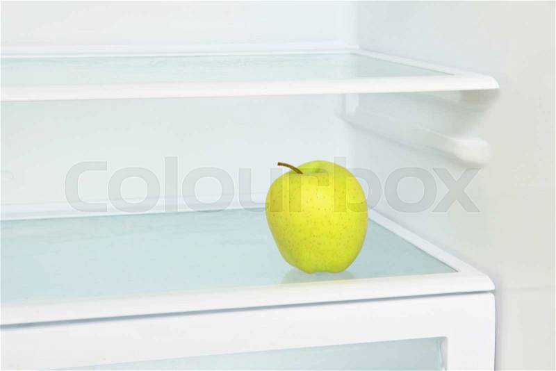 Lifestyle concept.Yellow apple in domestic refrigerator taken closeup.Toned image, stock photo