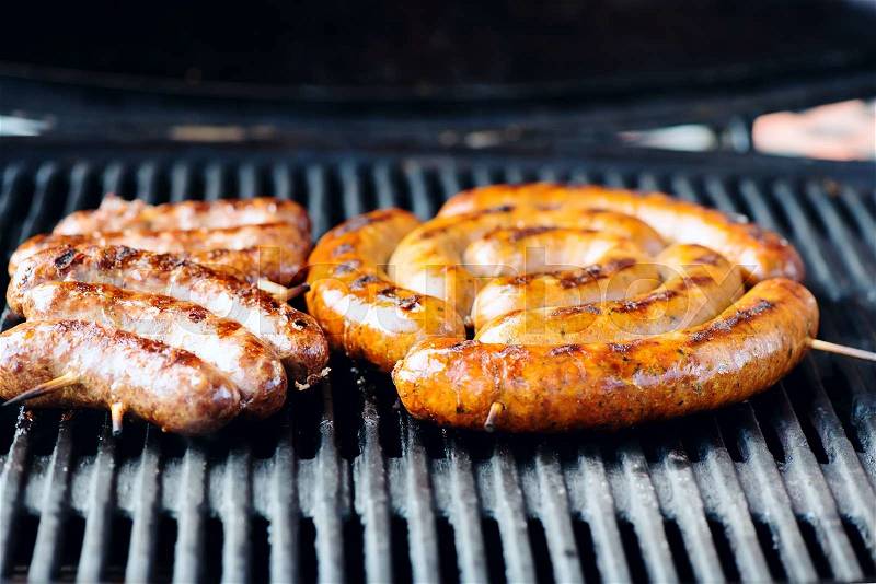 Grilled sausages on the grill, close-up, stock photo