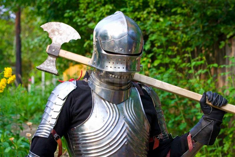 Knight in shining armor on a green background, stock photo