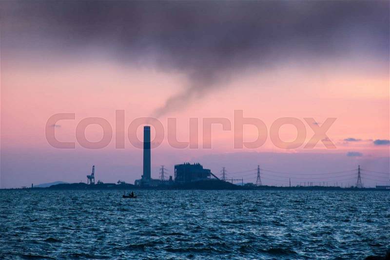 Sunset view of the heavy industry with smoking chimneys, stock photo
