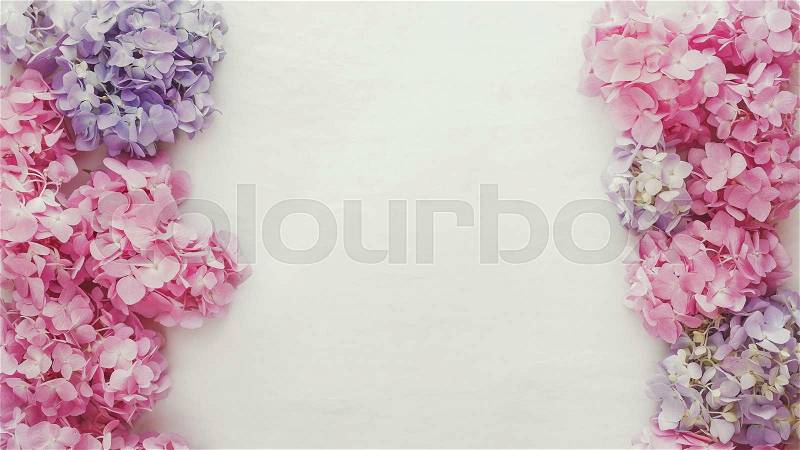 Vintage fresh hydrangea floral background. Natural hydrangea flowers on a rustic wood background. Top view, vintage toned image, blank space, stock photo