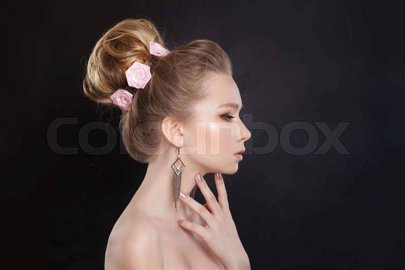 Pretty Woman. Makeup and Bridal Hairstyle with Rose Flowers. Profile, stock photo