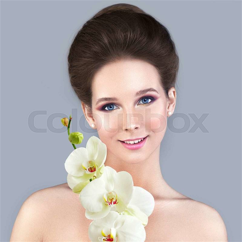 Spa Skin Care Concept. Healthy Woman with Clear Skin and White Orchid Flower, stock photo