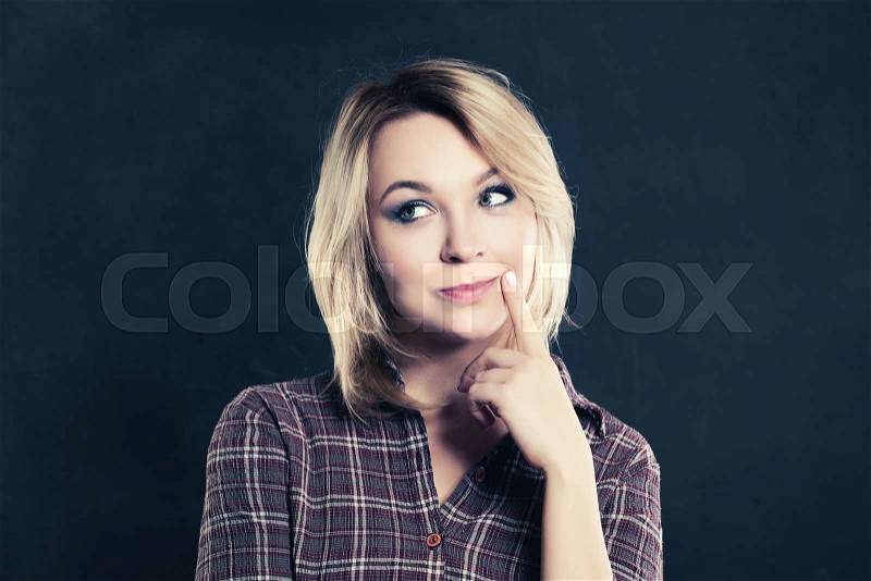 Thinking Woman on Dark Background, stock photo