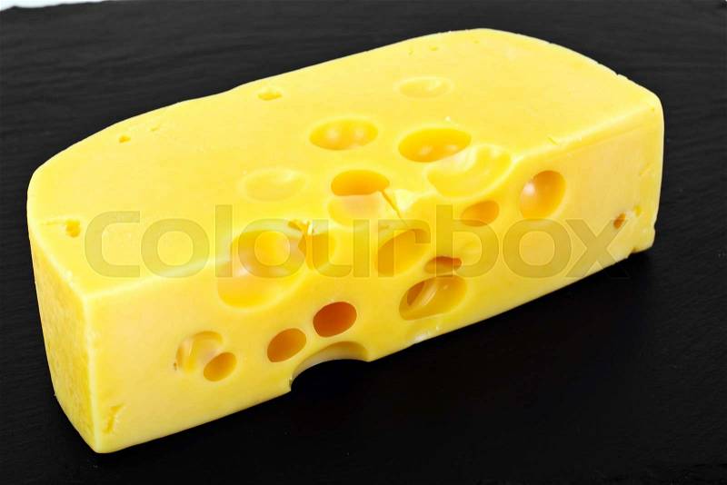 Swiss Cheese on Black Background Studio Photo, stock photo