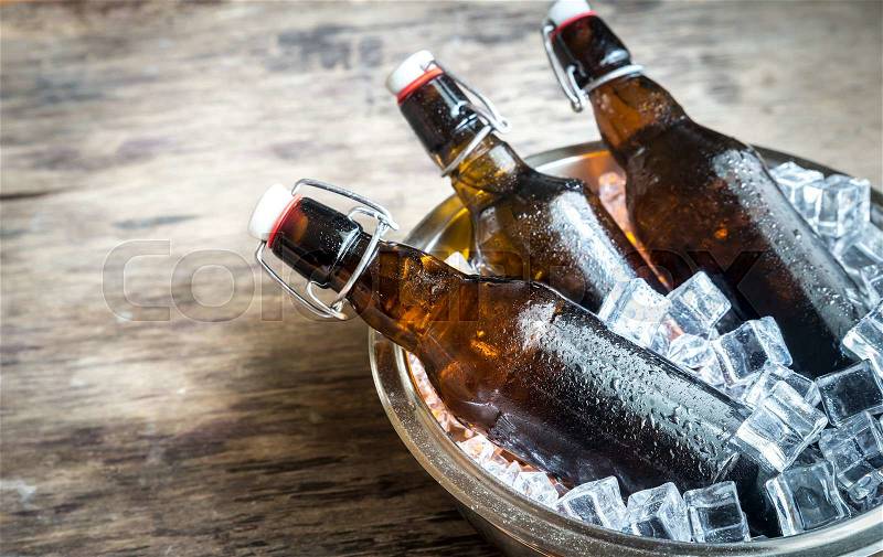Bottles of beer in ice cubes, stock photo