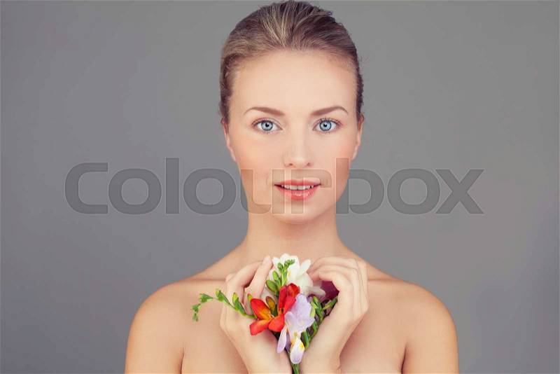 Spa Woman. Healthy Woman with Clear Skin and Flowers. Skincare Concept, stock photo