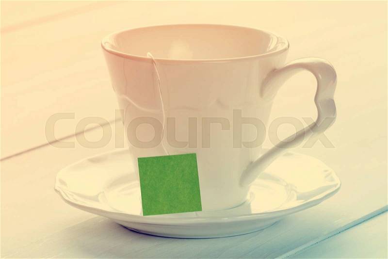 Soft pastel still life with teacup on wooden background, stock photo