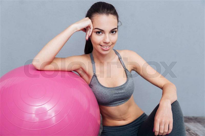 Close-up portrait of a healthy fitness girl isolated on grey background, stock photo