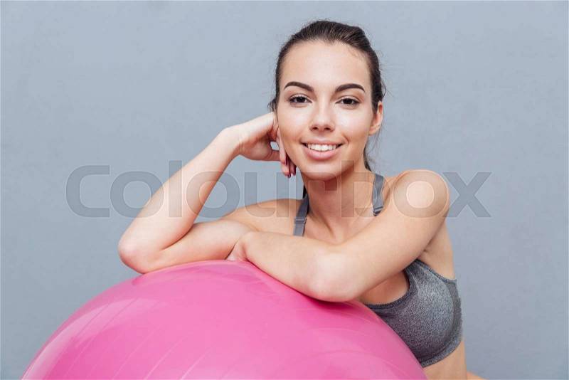 Close-up portrait of a healthy fitness girl isolated on grey background, stock photo