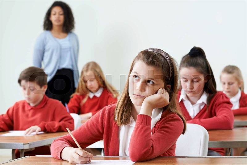 Female Pupil Finding School Exam Difficult, stock photo