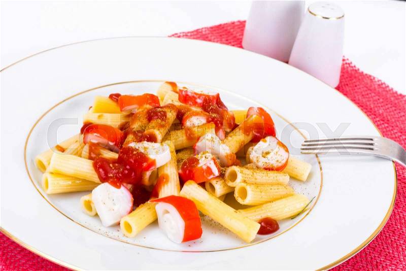 Pasta with Ketchup and Crab Sticks Studio Photo, stock photo