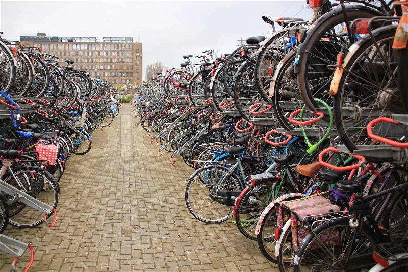 Many bikes on the biking place at the railway station in the city Leiden in spring, stock photo