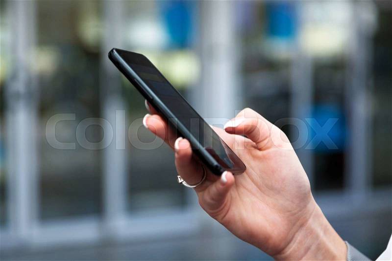 Businesswoman writes on sms airport. roaming charges abroad. accessibility by modern technology, stock photo