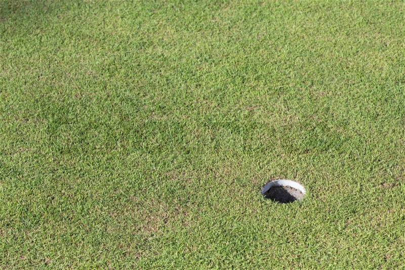 Golf hole on green grass, golf course, stock photo