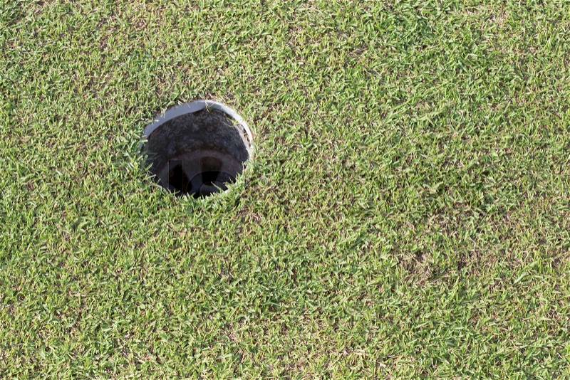 Golf hole on green grass, golf course, stock photo