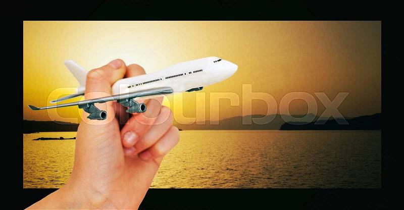 Child hand holding model airplane. Place for text, stock photo