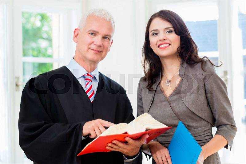 Lawyer and paralegal in their law office, stock photo