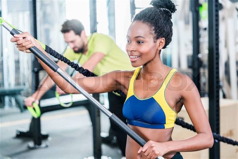 Woman and man in functional training for better fitness in sport gym, stock photo