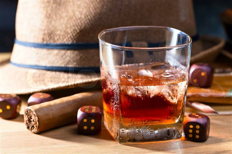 whiskey with ice and cigar on wooden table, stock photo